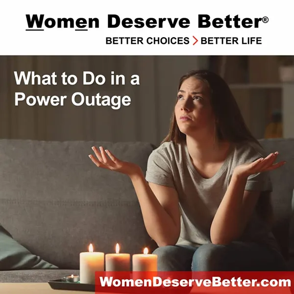 A woman sitting in front of lit candles